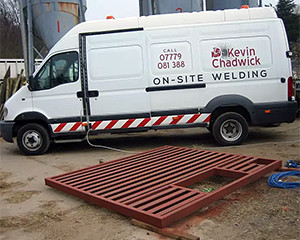 Van with welding in front of it